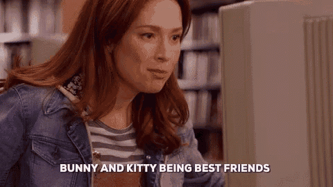 a woman in a denim jacket is sitting in front of a computer and says `` bunny and kitty being best friends '' .