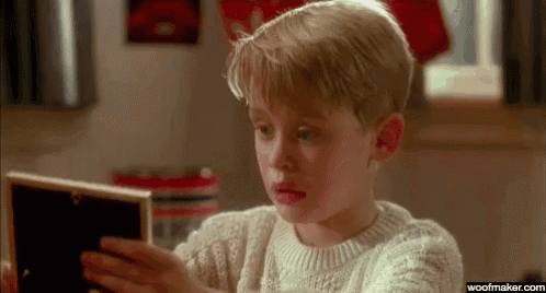 a young boy is looking at a picture in a picture frame .