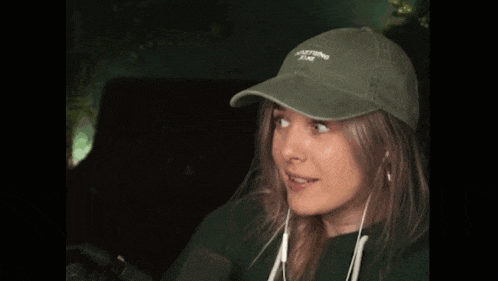 a woman wearing a green hat that says nothing time on it