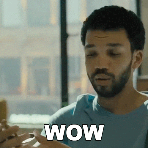a man with a beard is eating a hamburger and says wow