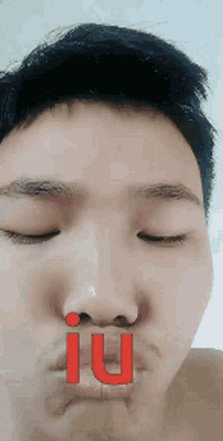 a close up of a man 's face with the word iu in red