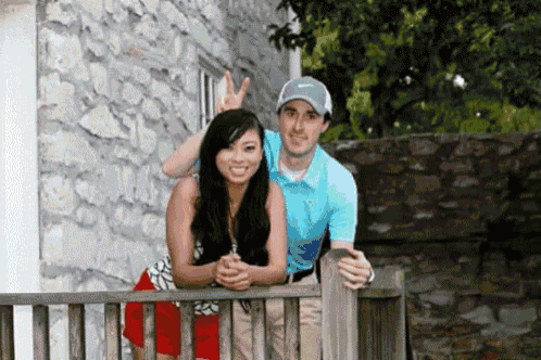 a man and a woman are posing for a picture and the man is wearing a nike cap