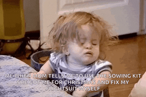 a little girl is sitting on a couch with her eyes closed and making a funny face .