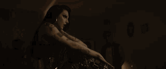 a woman with a tattoo on her arm that says ' i 'm a bitch '