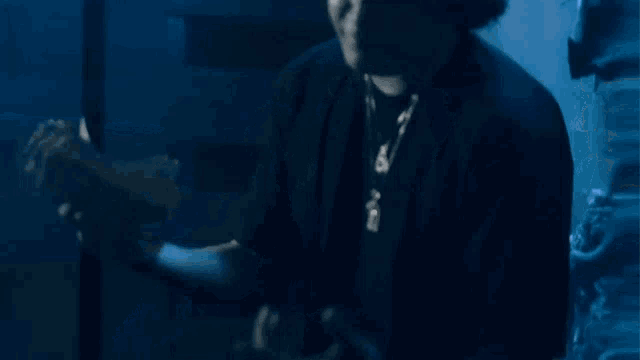 a man wearing a black hat with a gold letter p on it