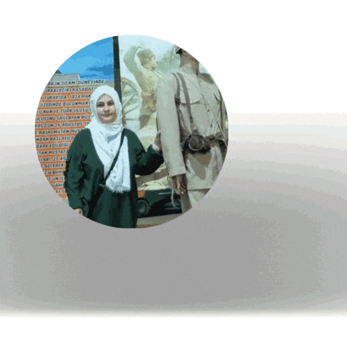 a woman in a hijab stands in front of a painting of a man in military uniform