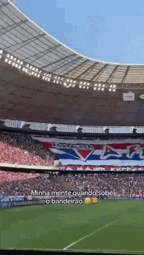 a soccer stadium with a banner that says minha mente quando sobe