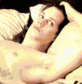 a naked woman is laying on a bed with her head on her hand
