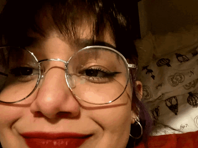 a close up of a woman 's face with glasses on