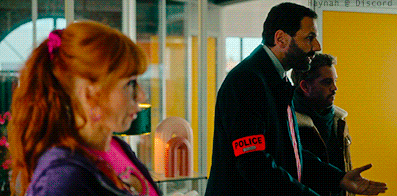 a man in a suit has a red sticker on his shoulder that says police