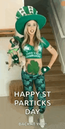 a woman in a leprechaun costume is standing on a set of stairs holding two pugs .