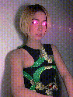 a woman wearing a black and green dress with a snake on it