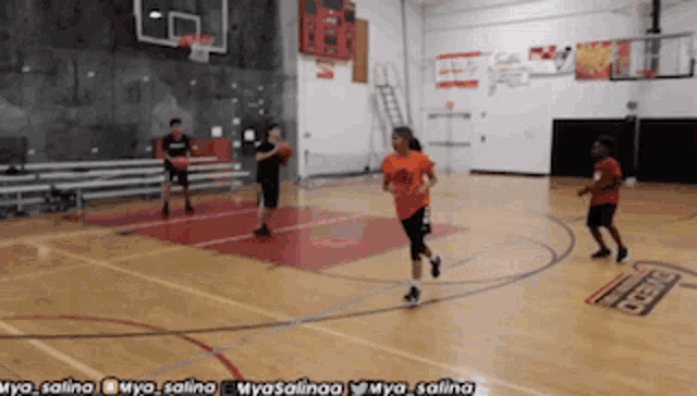 a group of kids are playing basketball in a gym with the hashtag myasalina on the bottom