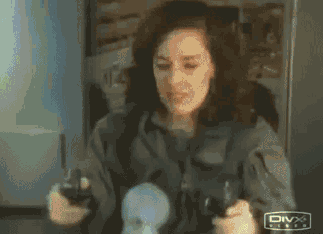 a woman is playing a video game with a remote control .
