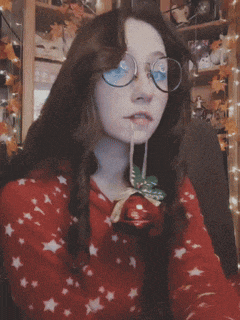 a girl wearing glasses and a red sweater with stars