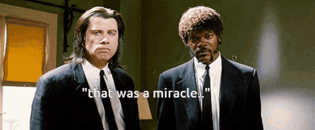 two men in suits and ties are standing next to each other and one of them says " that was a miracle " .