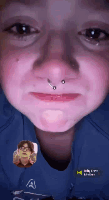 a close up of a person 's face with the name baby keem on the bottom