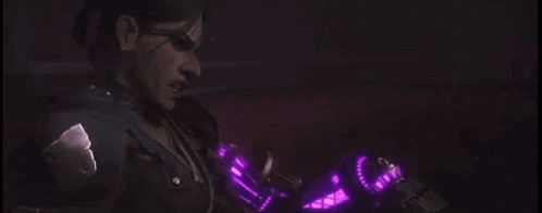 a woman is holding a purple object that looks like a gun