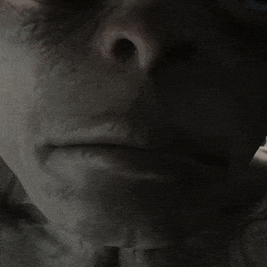 a close up of a face with blue eyes