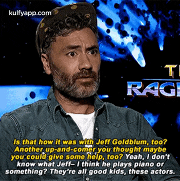 a man with a beard and hat is talking to jeff goldblum .