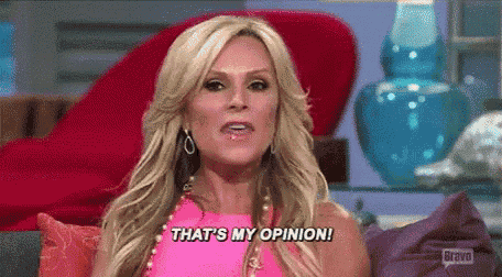 a woman in a pink dress is sitting on a couch and says `` that 's my opinion '' .