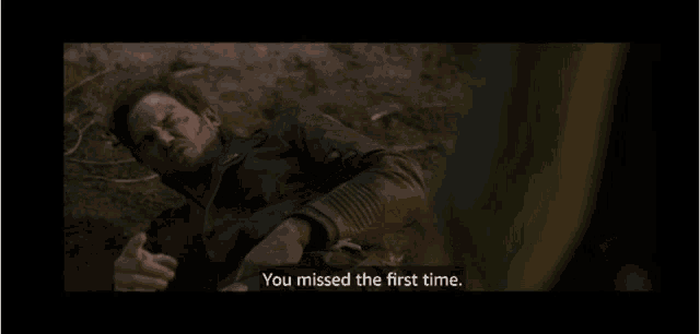 a man laying on the ground with the words you missed the first time