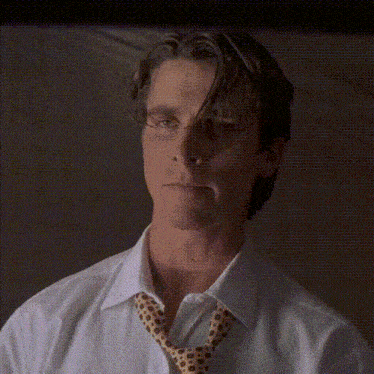 a close up of a man wearing a white shirt and a tie