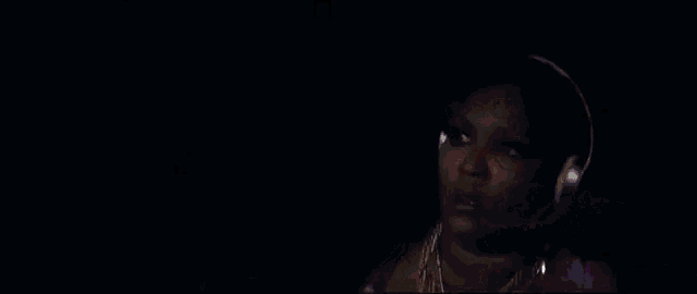 a woman in a purple robe is wearing headphones and a necklace .