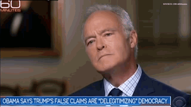 a man in a suit and tie is being interviewed by cbs news