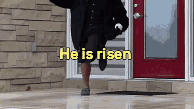 a man is running in front of a red door with the words he is risen on the bottom