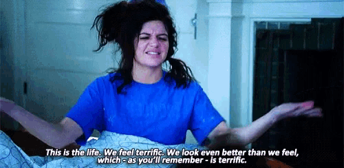 a woman is laying in bed with her arms outstretched and a quote .
