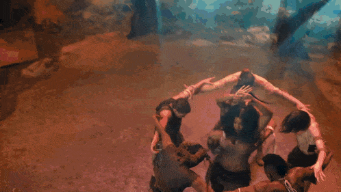 a group of people are standing in a circle with their arms outstretched