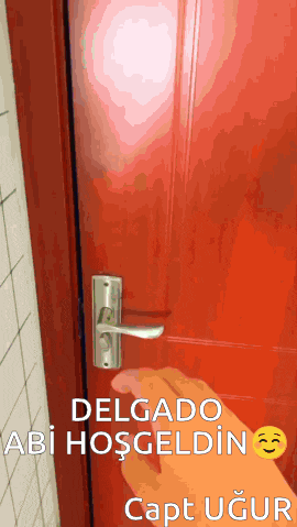 a person is opening a red door with the words delgado abi hosgeldin capt ugur on the bottom