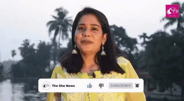 a woman in a yellow dress is crying in front of a sign that says " the she news "