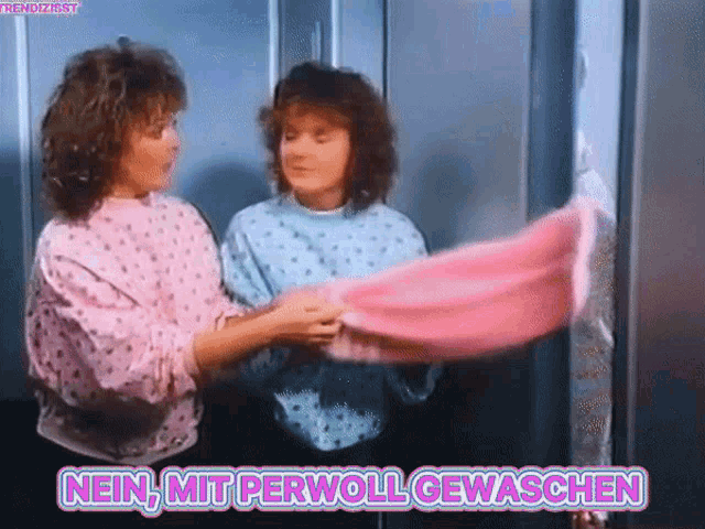 two women are standing next to each other with the words nein mit perwoll gewaschen