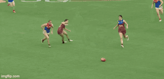 two female athletes are wrestling on a field with the url imgflip.com in the lower right corner