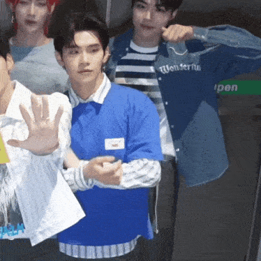 a man wearing a blue shirt that says wonderful