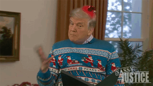 a man wearing a sassy justice christmas sweater