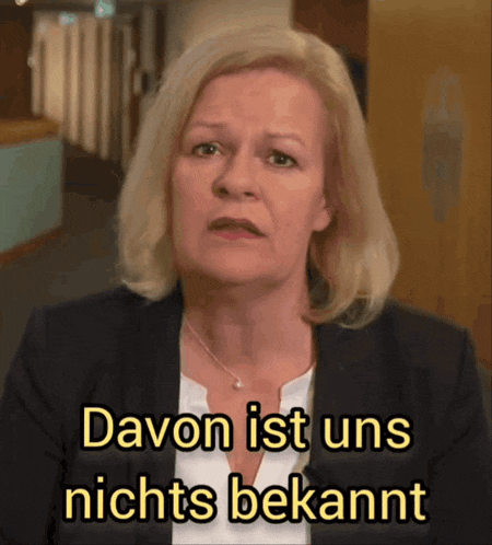 a woman in a black jacket and white shirt says davor ist uns nichts bekannt