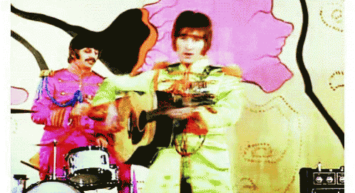 a man playing a guitar next to a man playing a drum