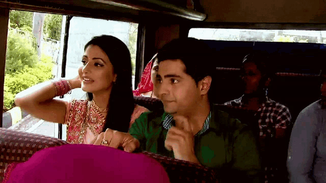 a man and a woman are sitting in a bus