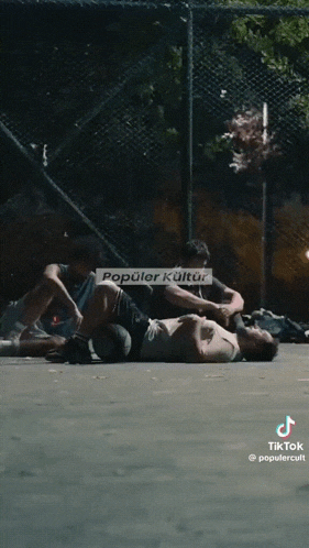 a man laying on the ground with popular kultur written on the bottom right