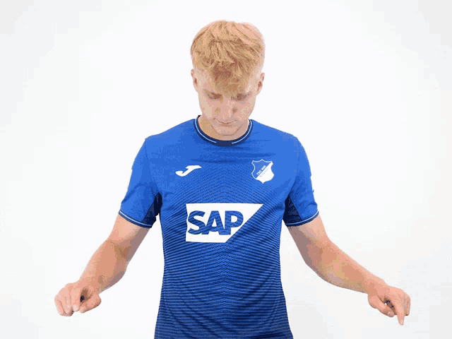 a man wearing a blue shirt that says sap on it