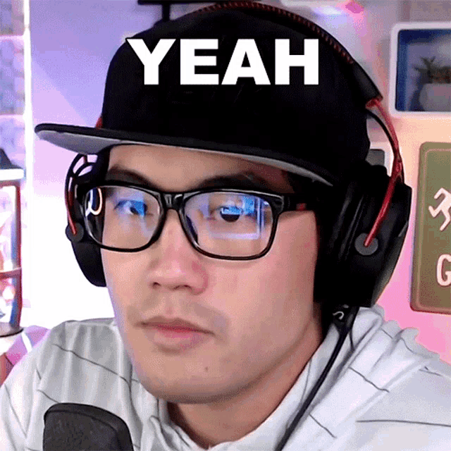 a man wearing glasses and headphones says yeah