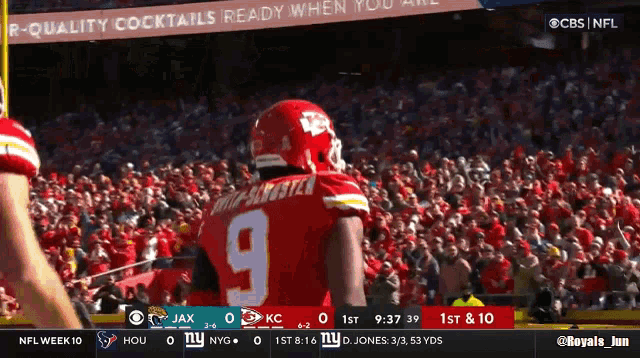 a football player with the number 9 on his jersey stands in front of a crowd