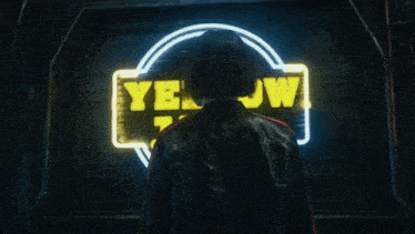 a woman is standing in front of a neon sign that says yellow jac
