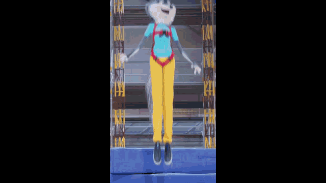 a husky mascot is sitting on top of a blue foam block .