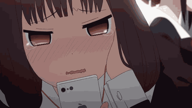 a girl with tears in her eyes is holding an apple iphone