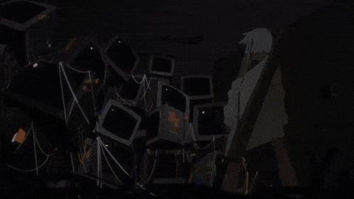 a bunch of televisions are stacked on top of each other in a room