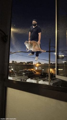 a picture of a man holding a rat with the caption made with mematic on the bottom